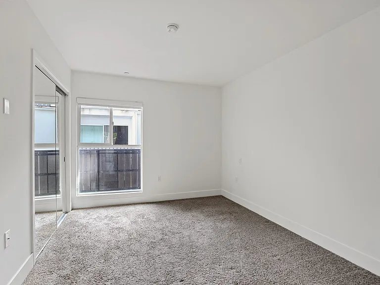 Bedroom with Mirrored Closet and Large-Size Windows