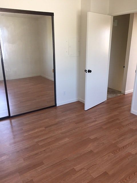Bedroom with mirror closet door