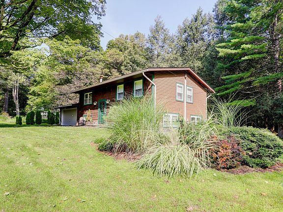 Front Yard with Small Garden at the side of the House and Woods in the Back Yard
