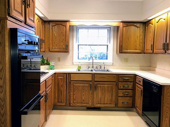 Kitchen has electric range, double oven, dishwasher, side-by-side refrigerator, lots of cabinet space