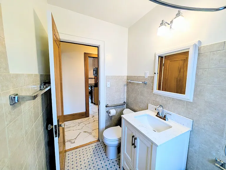 [UPPER UNIT]: bathroom with new vanity, new security block window, and new toilet