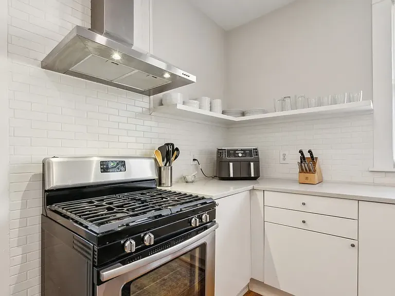 Kitchen stove, counter, and shelves