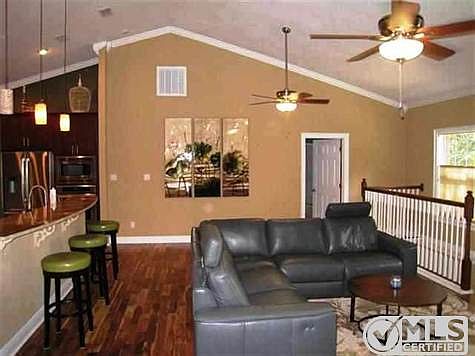 Fabulous soaring ceilings, seating at granite bar, room for dining table.