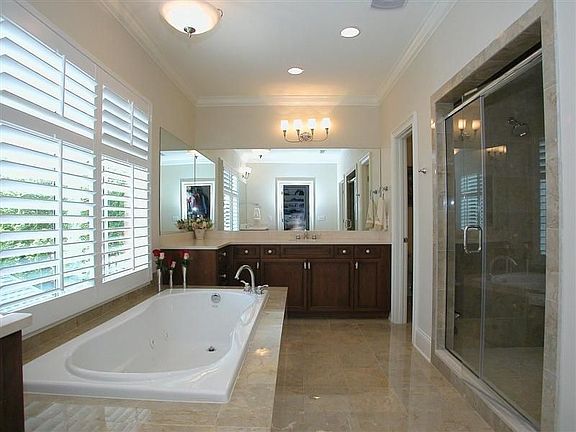 Master bath has separate vanities, jacuzzi tub and oversized walk-in shower