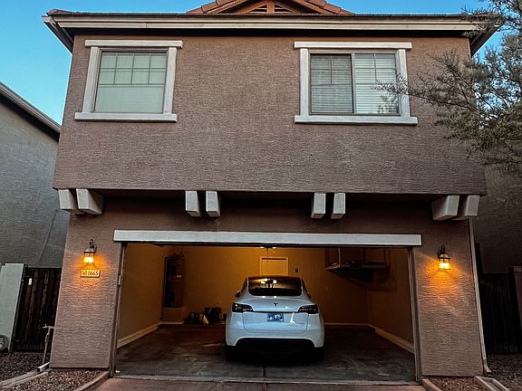 back of home with built in 2 car garage and 220v fast charging for smart car