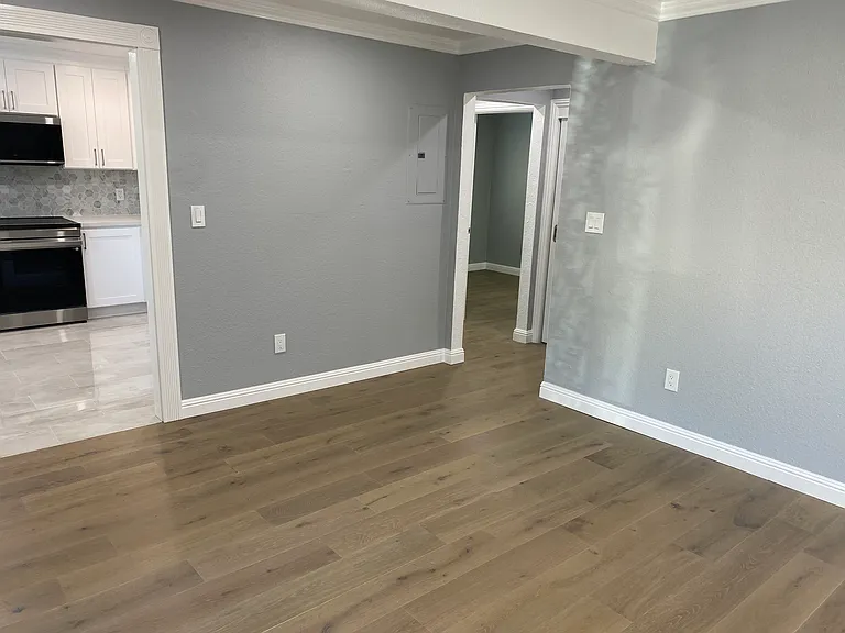 Living Room facing kitchen and hallway