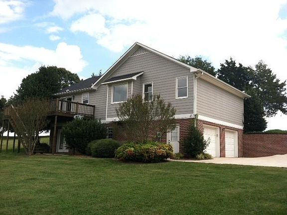 Back showing garage entry, downstairs room french doors.