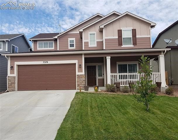 Front of house. Large covered front porch is perfect for relaxing outside. This garage is a tandem so you can park 3 cars inside or use the extra space for a workshop.