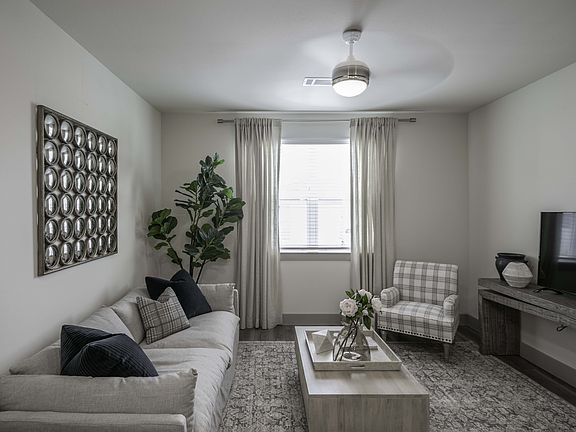 Open living area with Ceiling Fans