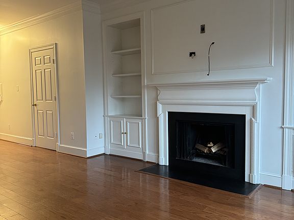 Wood burning fireplace with built-in bookshelves and cabinets
Laundry room door to the left