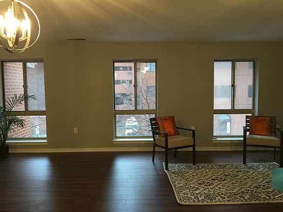 living room with three bright windows