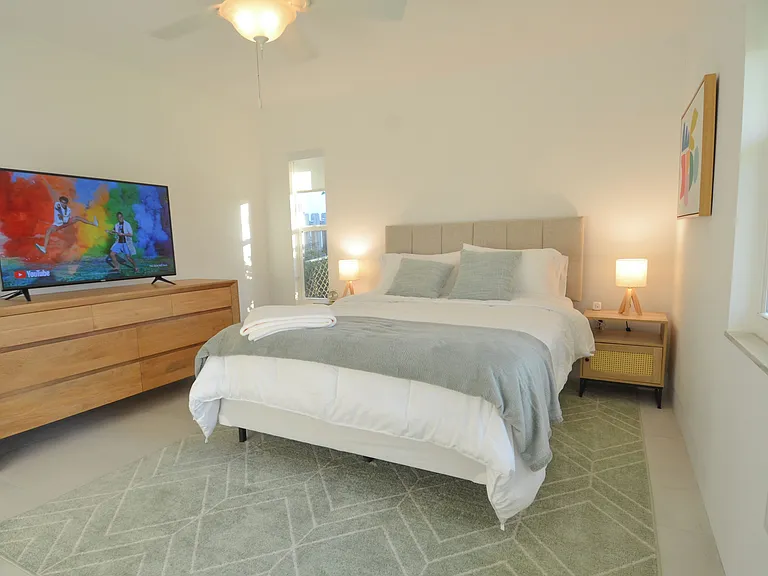 Second bedroom, queen bed with smart TV, closet and dresser