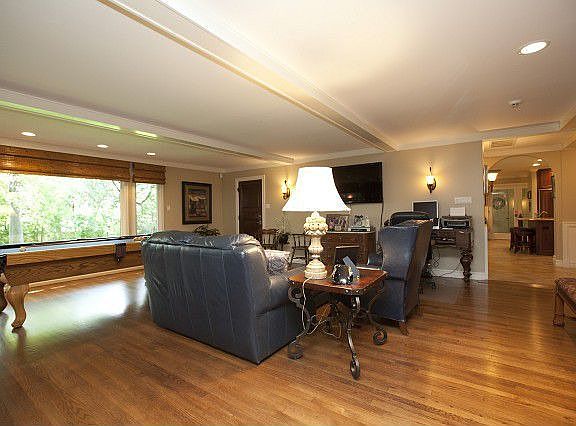 Hardwood floors and beamed ceiling in living room