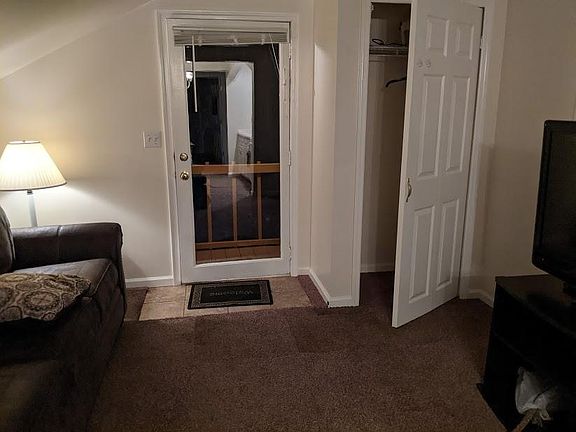 Entry door & living room closet, Furnished with TV, Cable & Wifi, leather couch + swivel rocker cloth chair.