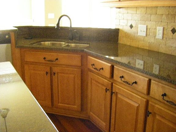 Kitchen has granite counter tops, stainless appliances and much more