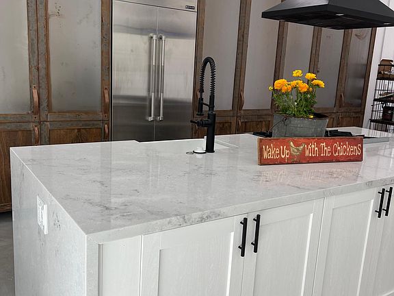 Custom made tall cabinets with a water falls island