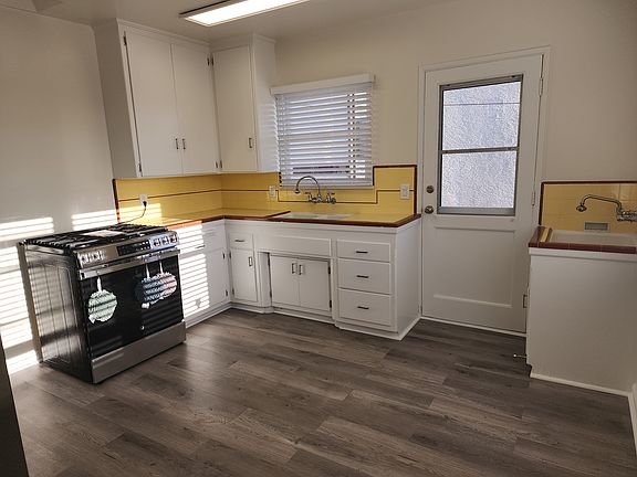 Kitchen facing south. Back entrance to unit.