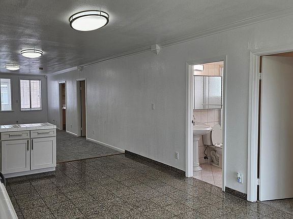 View from the kitchen to the entrance of the house and the second full bathroom to your right