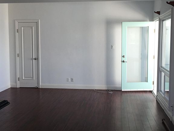 Unbelievably large living room with that breathtaking ocean views and beautiful beamed ceilings and wood floors