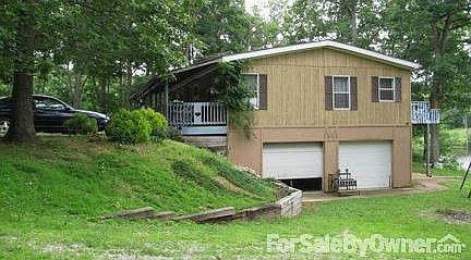 side view
						:
						2 car garage with entry into house. Right corner shows distance to lake.