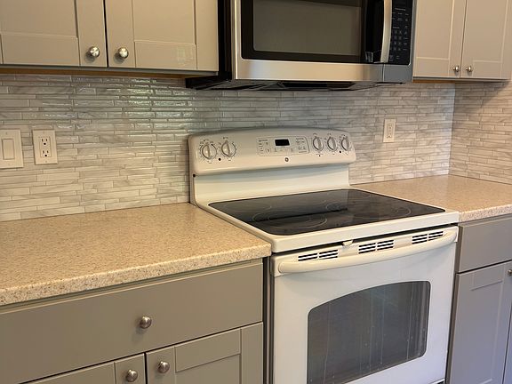 Brand new cabinets, countertops, backsplash, hardware and microwave