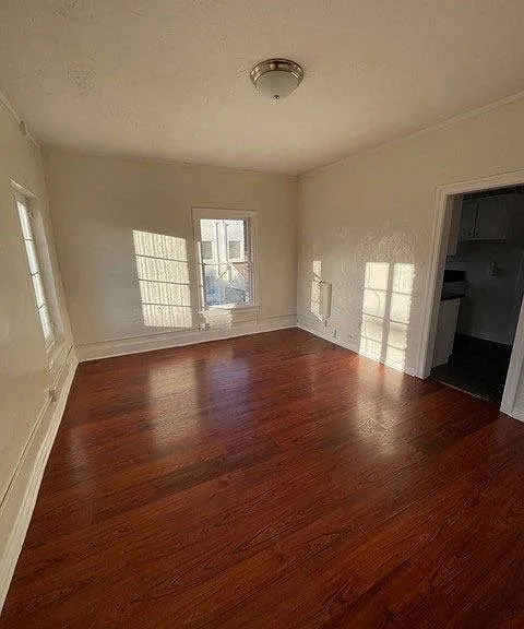 Lots of natural light and beautiful craftsmanship in living room of apartment unit at Molino Del Mar Apartments in Pasadena, California.