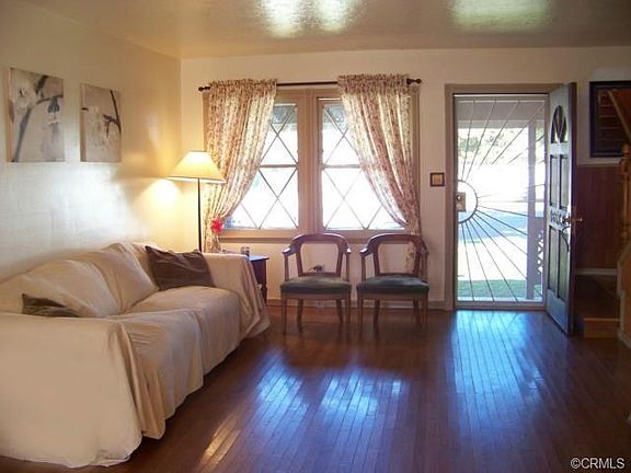 Living room has wonderful wood floors, new paint and lovely wind