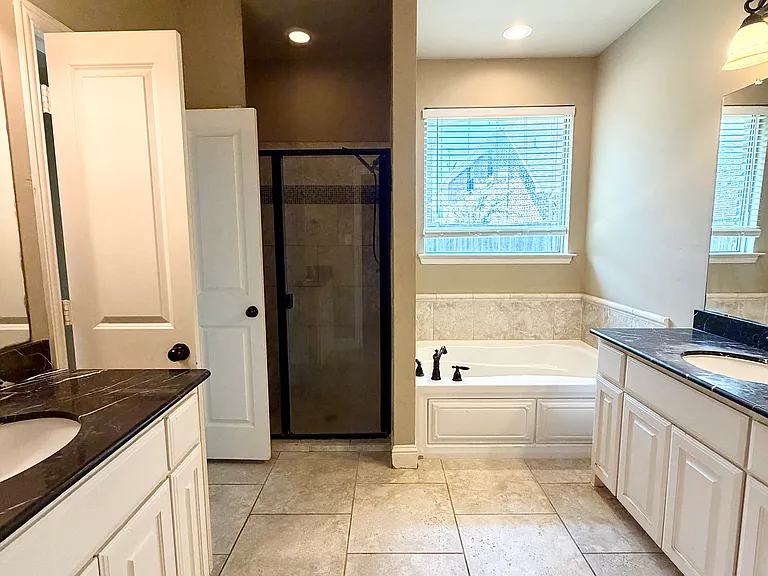 Primary bedroom connected bathroom with shower and tub