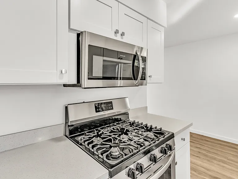 Updated kitchen features modern cabinetry, stainless steel appliances.
