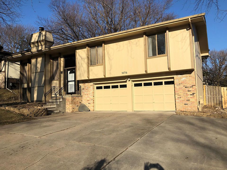 Front of house with 3-car wide drive-way for extra, off-street parking, and two car garage with openers
