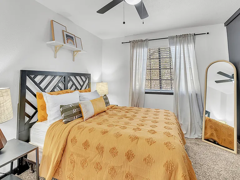 Experience comfort and style in this beautifully decorated bedroom space.