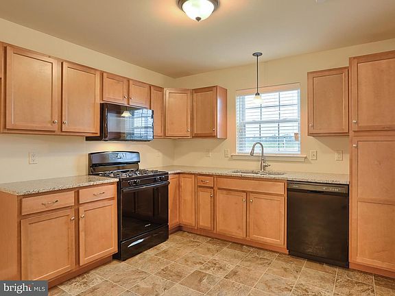 Large kitchen with granite countertops