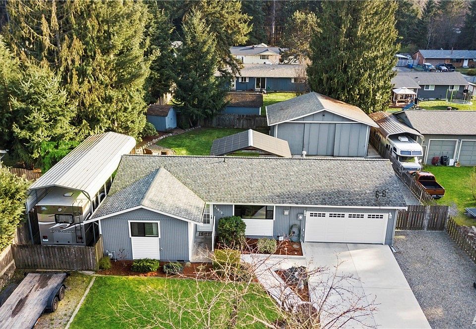 Hobbyist and car love paradise~Immaculate Bonney Lake one level living with garages for 5 cars located on level, fully fenced 1/4 acre lot~Covered RV parking