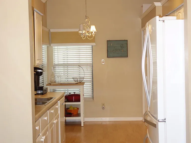 Eat in kitchen has a large screened porch and fenced yard which is on an easement outside of this back wall window.