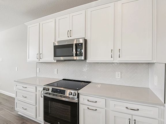 Stainless steel appliances cabinets and drawers with the AW Collection R Timeless as the backdrop