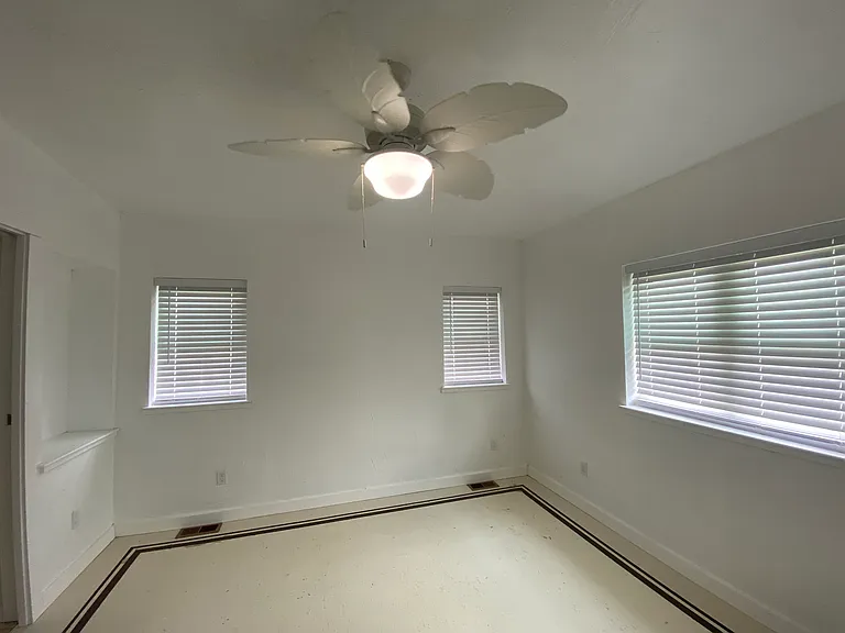 All bedrooms come complete with wooden blinds to block light and provide privacy. This master bedroom has a built-in nook for decorative items to accent the room.