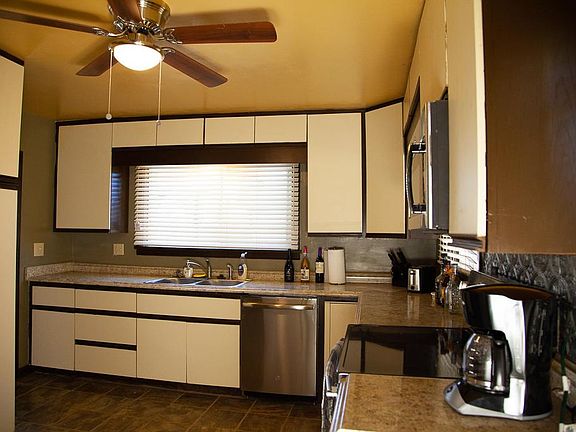 Kitchen with plenty of counter space, storage, dishwasher, and microwave.