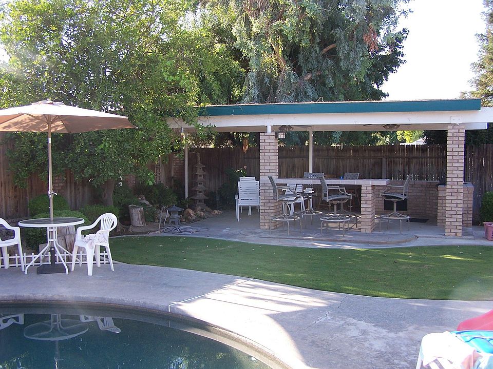 back yard built in bbq and waterfall with ceiling fans