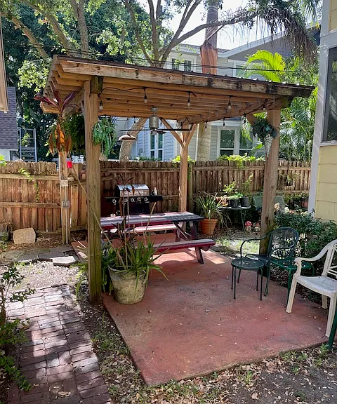 Common area outside with gas grill and covered seating