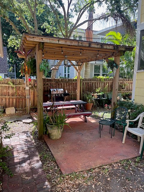 Common area outside with gas grill and covered seating