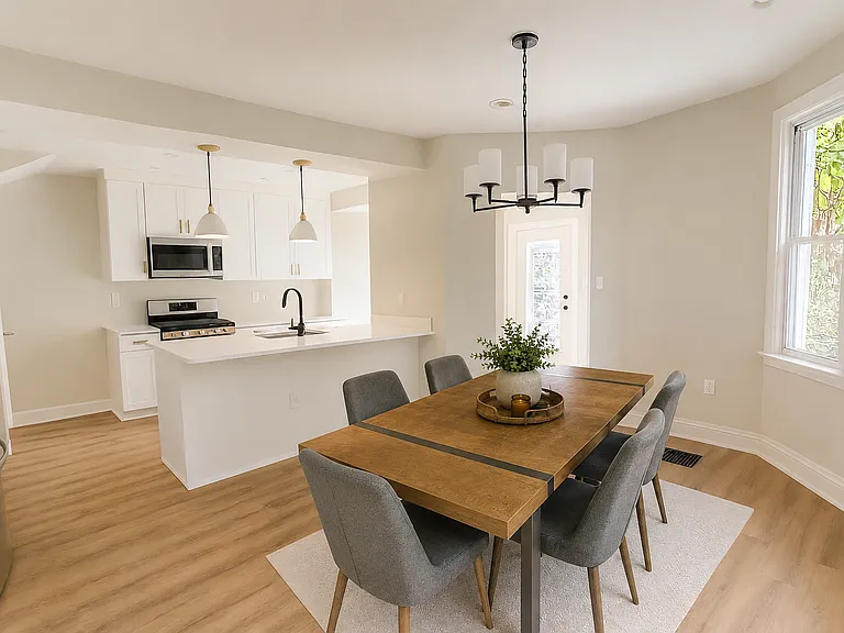 Kitchen and dining area. The table and chairs are new from 2025 and can convey with the home.