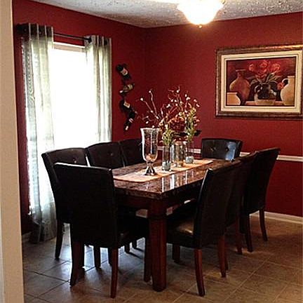 Lovely formal dining room with window looking out onto the front lawn.