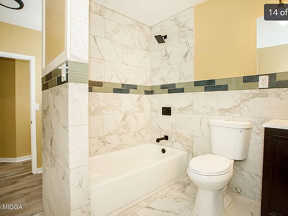 Clean bathroom with a vanity sink, neutral wall colors, and natural light from the window.