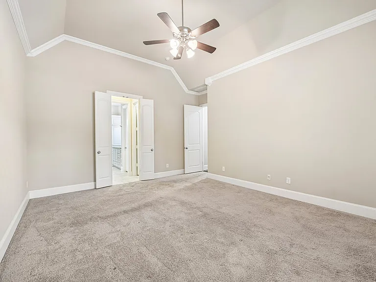 Primary bedroom - Ceiling fan and love the moulding and neutral colors.