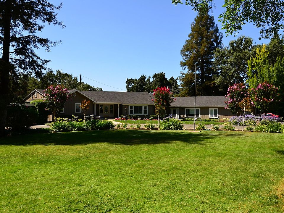 Single story rancher on one acre. 75B is the attached unit on the right with its own entrance. This is the view from front circle