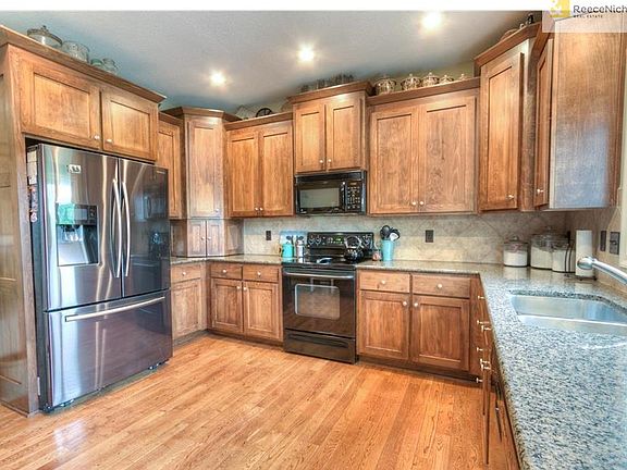 Well equipped kitchen with granite counters