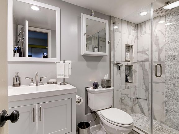 Custom Marble Bath with Tall Vanity, Medicine Cabinet, Speakers & Glass Shower wth Rain Massage Showerhead!