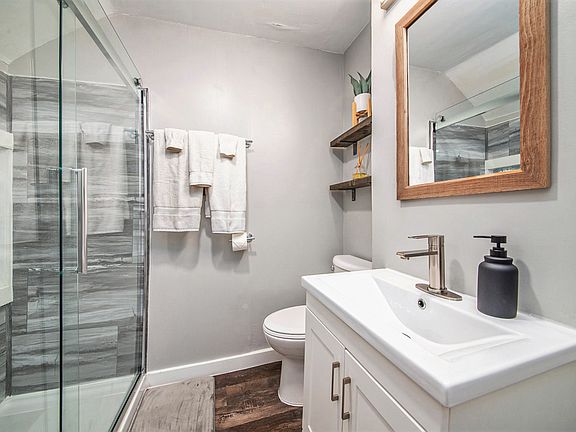 Bathroom with full size shower, glass doors, and towels