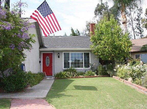 Front yard - attached garage and driveway with parking for two cars off to the left.