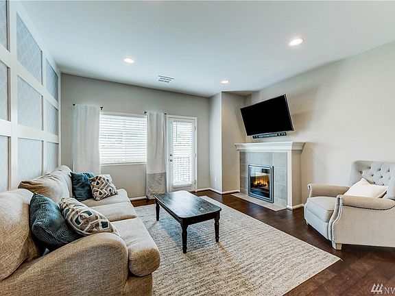 Living room with door to balcony overlooking backyard